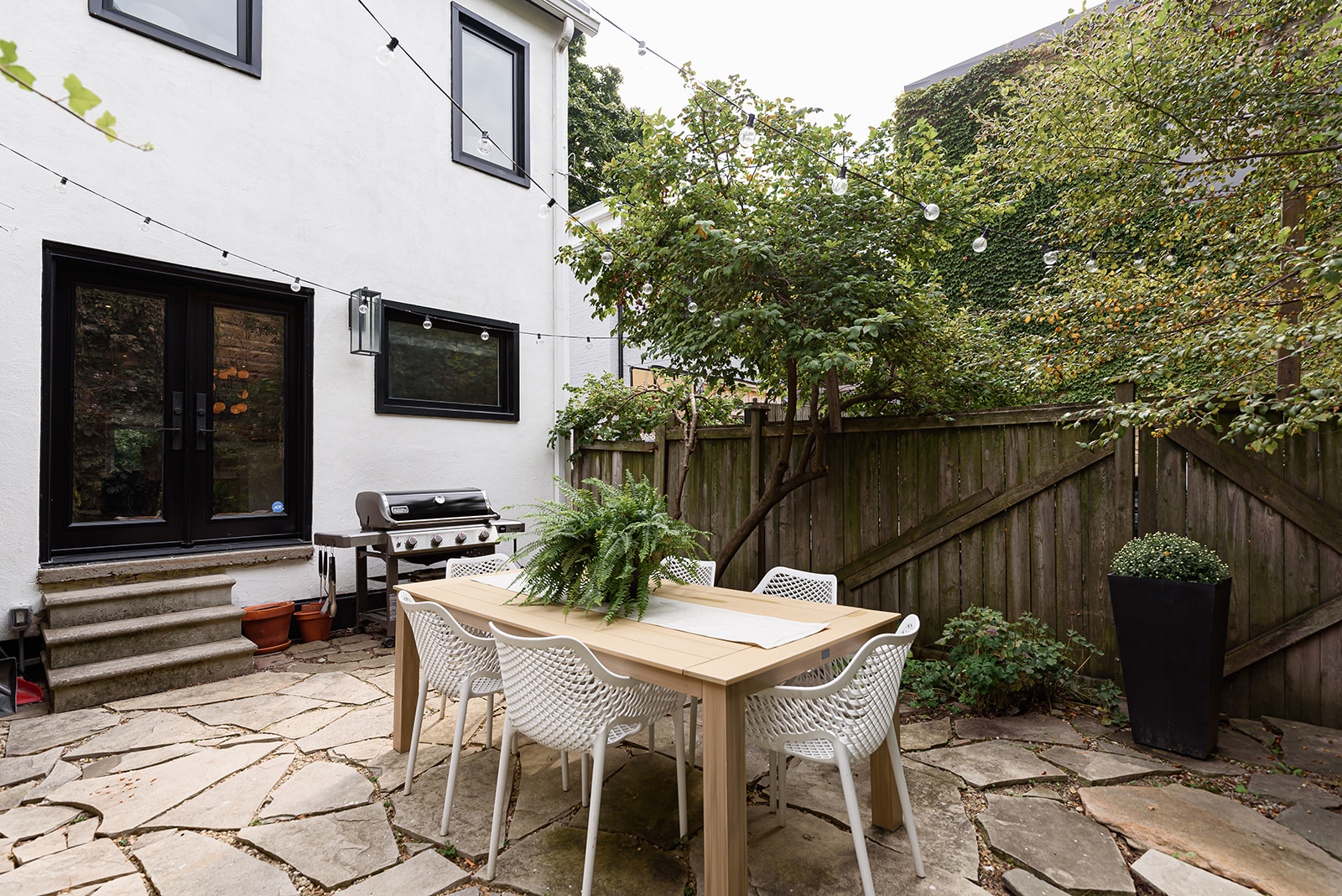 A patio with a table and chairs.