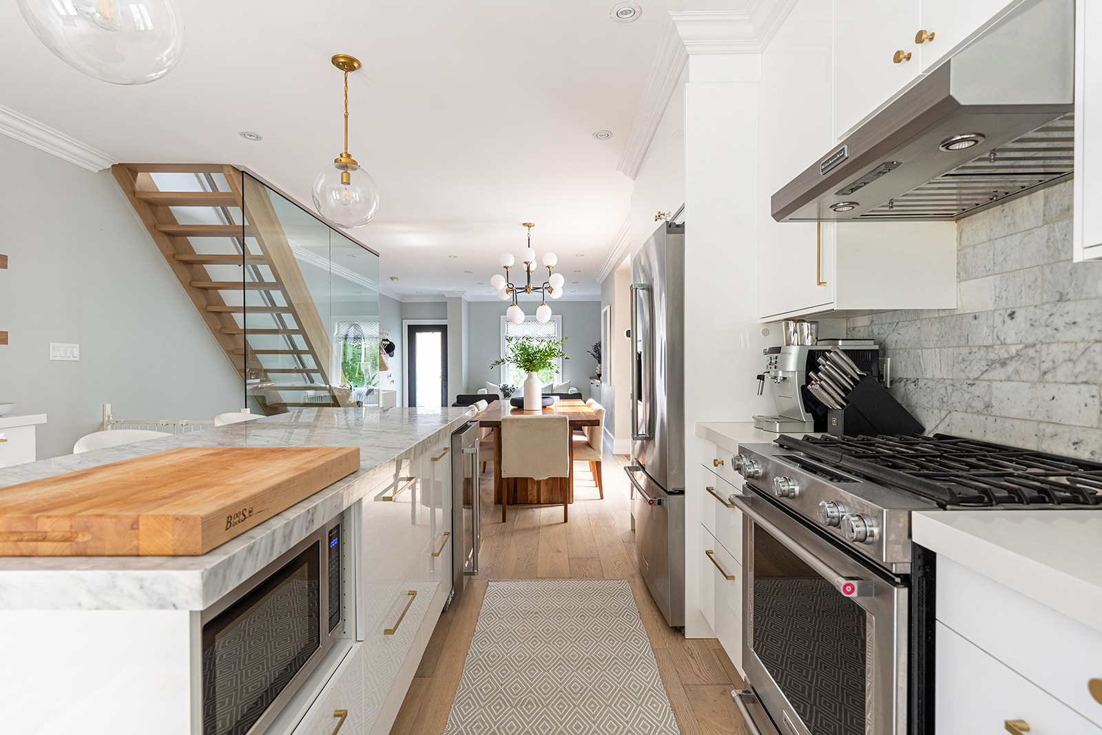 A kitchen with white cabinets and stainless steel appliances.