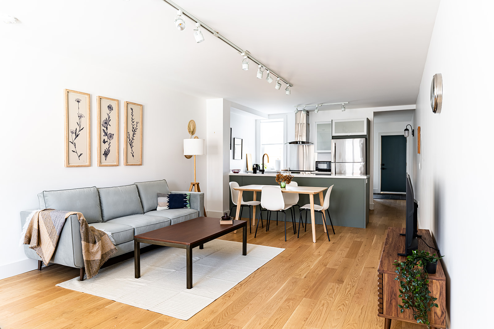 A living room and dining room in a modern apartment.